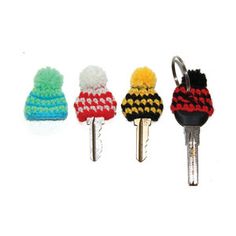 four knitted key fobs are lined up next to each other