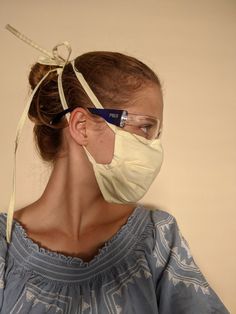 a woman wearing a face mask and glasses