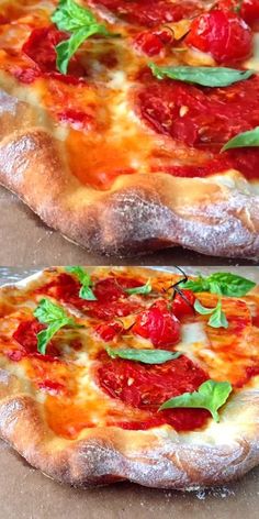 two pizzas with tomatoes and basil on them sitting on top of a table next to each other