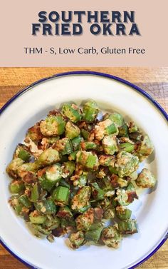 a white plate topped with fried okra on top of a wooden table