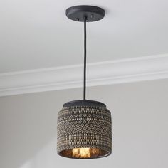 a light fixture hanging from the ceiling in a room with white walls and black trim