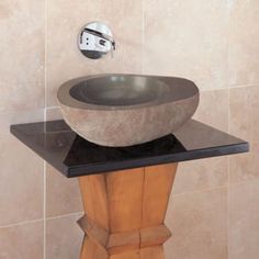 a bathroom sink sitting on top of a wooden stand