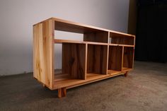 a wooden shelf sitting on top of a carpeted floor