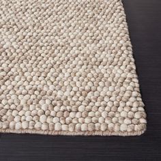 a white rug on top of a wooden floor