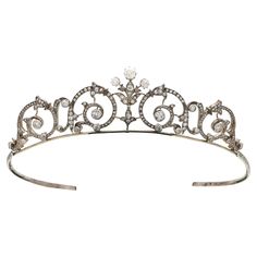 A truly elegant Edwardian old cut diamond tiara set in silver and gold, circa 1910. This beautifully handcrafted tiara is composed of a number of elegant foliate scroll motifs, commonly seen within the Victorian and Edwardian jewellery eras. The tiara is centred with a fleur-de-lis inspired spray, topped with the three largest old mine cut diamonds in the tiara. There is a grand total of 264 diamonds set within the piece and due to the spread of the design sparkles from all angles. This tiara is Diamond Headpiece, Tiara Gold, Tiaras Jewellery, Pearl Tiara, Edwardian Jewelry, Diamond Tiara, Gold For Sale, Wedding Day Inspiration, Family Jewellery