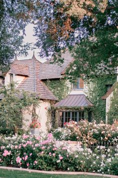 a house with many flowers in front of it