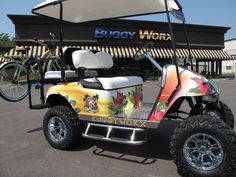 a colorful golf cart parked in front of a building