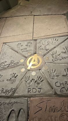 handprints are on the sidewalk near a manhole cover