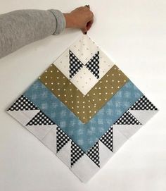 a person is cutting up a patchwork quilt