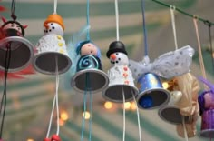 small bells hanging from strings with snowmen on them