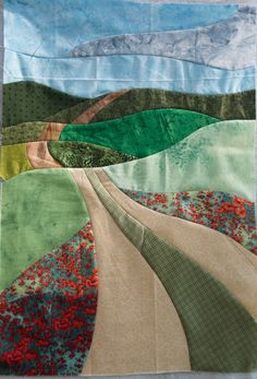 a patchwork quilt with an image of a road going through the countryside on it