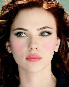 a woman with red hair and green eyes