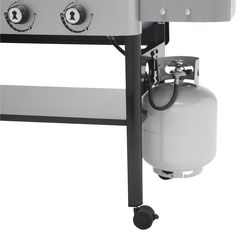 an outdoor gas grill with a propane tank attached to the front and side burners