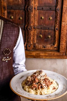 a person holding a plate with food on it