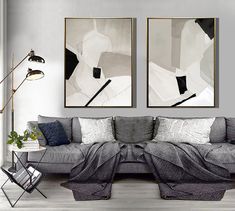 a living room with two paintings on the wall