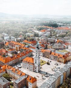 an aerial view of a city with orange roofs