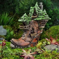 a pair of boots that are sitting in the grass with trees on top of them