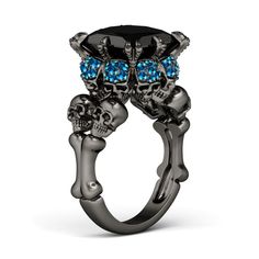 a ring with skulls and purple stones on it