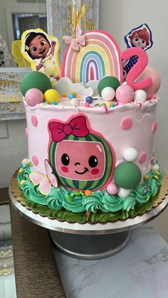 there is a cake decorated with cartoon characters on the top and decorations in the bottom