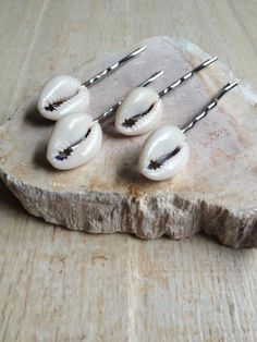 These cowrie shell hair pins would be great as a set or on their own! They would be a perfect addition for a beach wedding, summer vacation, music festival, mermaid costume or for everyday fun. The shells and are securely attached to a silver metal hair pin that is two inches in length. The cowrie shells are 3/4 inch in height and 1/2 inch in width. This shell hair pin is also available in gold and bronze finish, see the last photo. SAVE Order 10 and get one FREE SEVENTEEN cowrie shell hair pins Girl Mermaid Costume, Cowrie Shell Hair, Festival Mermaid, Music Festival Birthday, Girls Mermaid Costume, Hippie Music, Pool Party Favors, Seashell Projects, Mermaid Crafts