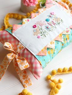 a close up of a decorative pillow on a table