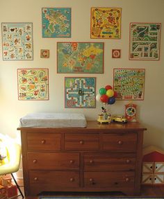 a baby's room with lots of pictures on the wall and a crib