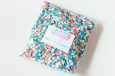 a bag filled with confetti and sprinkles on top of a table