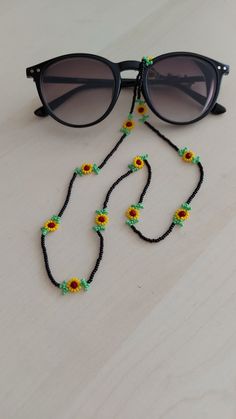 a pair of sunglasses with beads and flowers on them