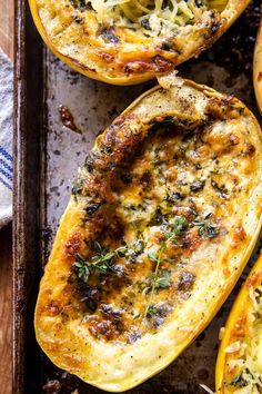 baked stuffed squash with cheese and herbs on a baking sheet, ready to be eaten