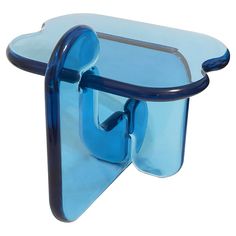 a blue glass shelf with two hooks on it