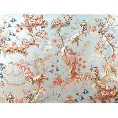 a blue and pink wallpaper with birds, flowers and butterflies on it's side