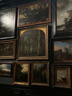 many paintings are hanging on the wall next to each other