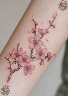 a woman's arm with pink flowers on it