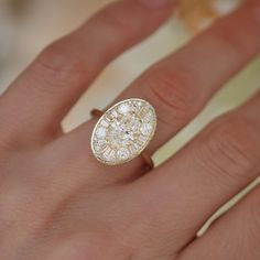 a woman's hand with a diamond ring on it