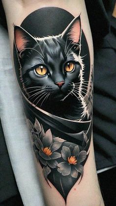 a black cat with yellow eyes is on the arm