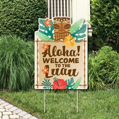 a welcome sign in front of a house with flowers and tiki masks on it