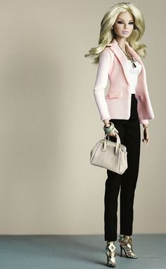 a barbie doll holding a handbag and purse