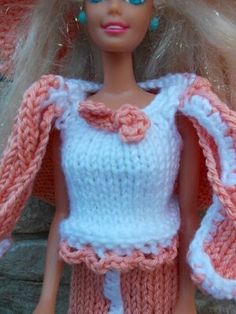 a barbie doll wearing a pink and white outfit