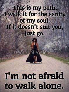 a woman walking down a dirt road with the words, i'm not afraid to walk