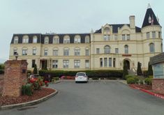 a car parked in front of a large building