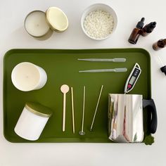 a tray with spoons, measuring cups and utensils on it