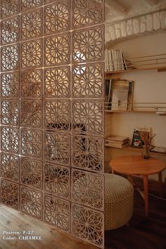 the room divider is made out of wood and has an intricate design on it