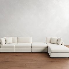 a white couch sitting on top of a wooden floor