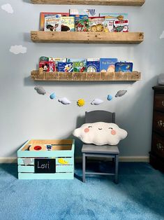 a child's room with blue carpet and two wooden shelves on the wall above a chair