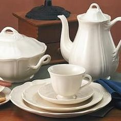 there is a white tea set on the table