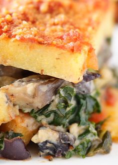 a close up of a plate of food with spinach and other foods on it