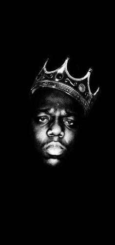 a man with a crown on top of his head in front of a black background