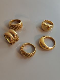 Because a lot of customer-friends love chunky rings, I made a collection of my wide rings. I hope you love these big golden rings. ♥ SIGN UP for 10% OFF your first order: https://bit.ly/3olIlWf ♥ DETAILS - Materials: Stainless steel, 18k gold plating. - Nickel-free, anti-corrosion, tarnish-resistant, and hypoallergenic. - Safe for sensitive skin. - Waterproof Ring: you can wear it while taking a shower or washing your hands. ♥ STYLE ⇨ A - Croissant Ring ⇨ B - Double Dome Ring ⇨ C - Themis Ring ⇨ Gold Rings On Black Women, Dome Rings Gold, Gold Right Hand Rings, Thick Rings For Women, Thick Ring Gold, Gold Chunk Jewelry, Gold Rings Inspiration, Thick Rings Aesthetic, Gold Y2k Rings