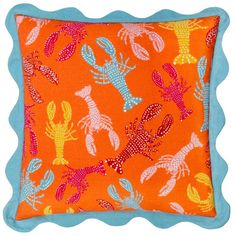 an orange and blue pillow with lobsters on it