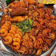 a large platter filled with shrimp and other foods